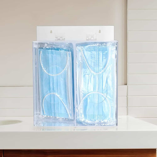 2-compartment acrylic dispenser filled with face masks on a bathroom countertop