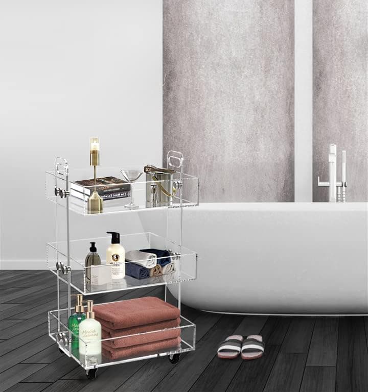 3-tier acrylic rolling cart holding bath essentials and towels next to a bathtub