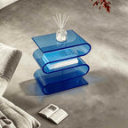 Top view of 3-tier klein blue acrylic end table, modern curved side table with books and diffuser decor
