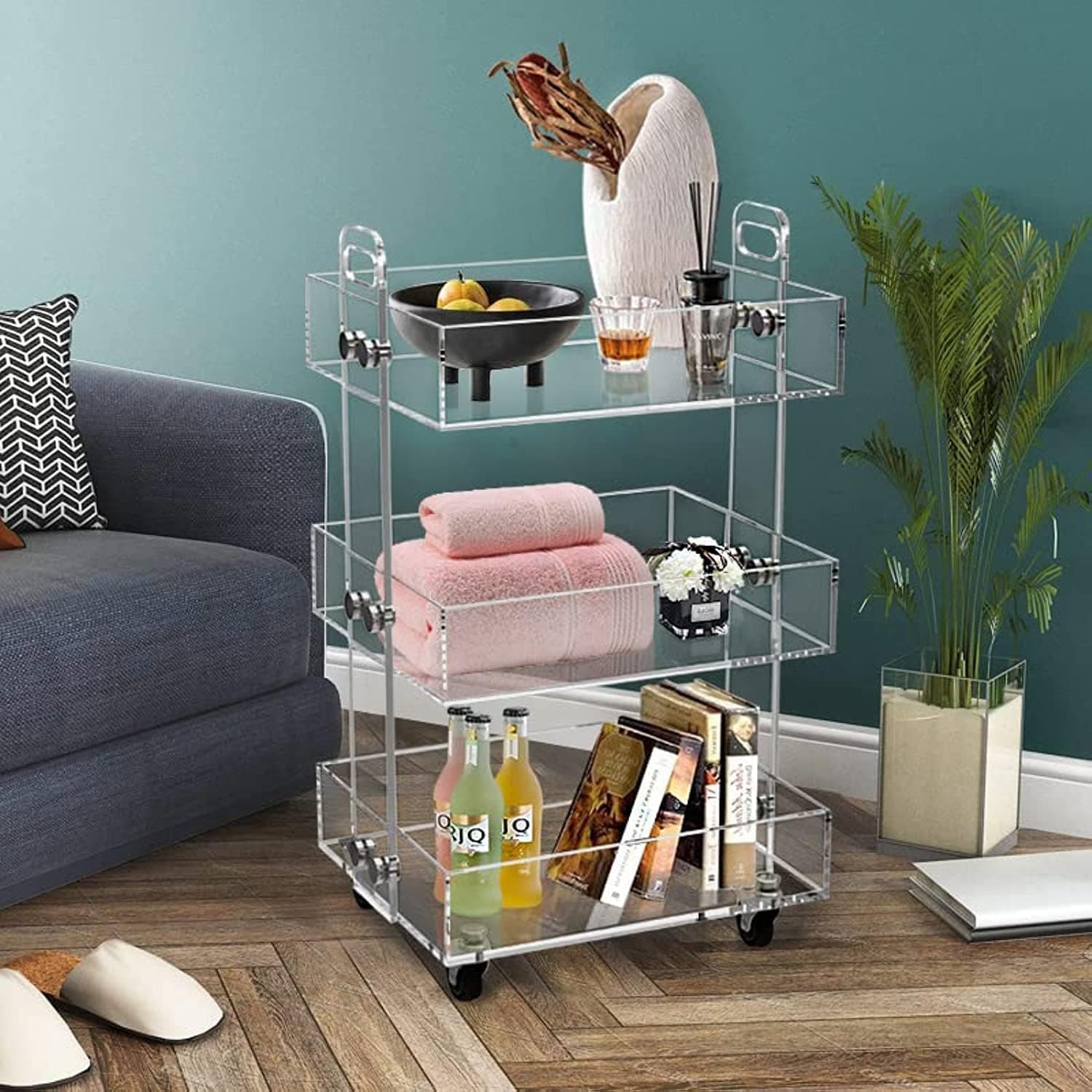 3-tier acrylic rolling cart styled as a living room serving cart with drinks, towels, and books