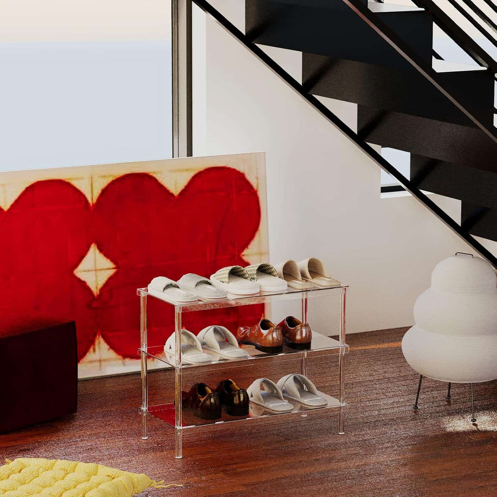 3-tier clear acrylic shoe rack in a modern living space with a red heart artwork and black staircase