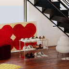 3-tier clear acrylic shoe rack in a modern living space with a red heart artwork and black staircase