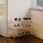 3-tier clear acrylic shoe rack in an entryway corner, storing slippers and casual shoes