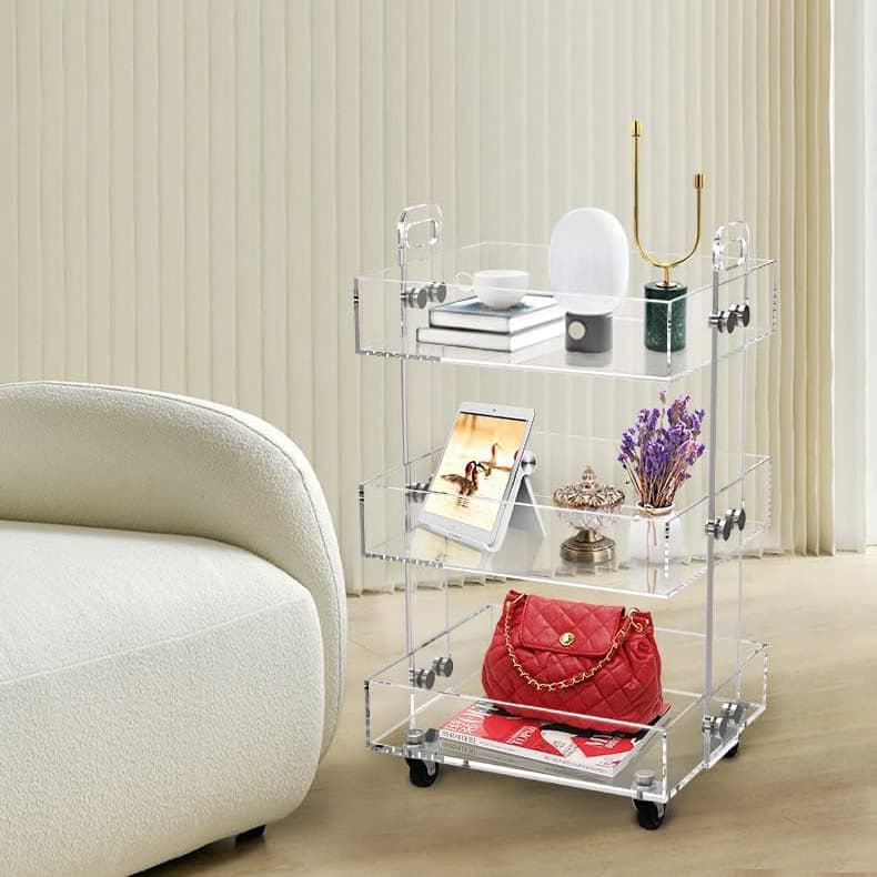 3-tier clear acrylic bar cart holding liquor, fruit, and decor in a modern living space