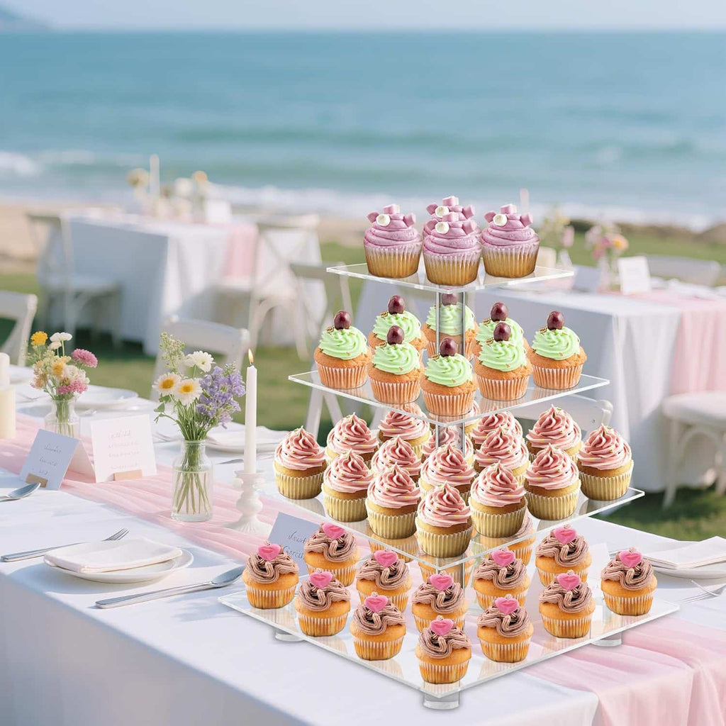 4 tier clear cupcake stand at a beach wedding reception with ocean backdrop