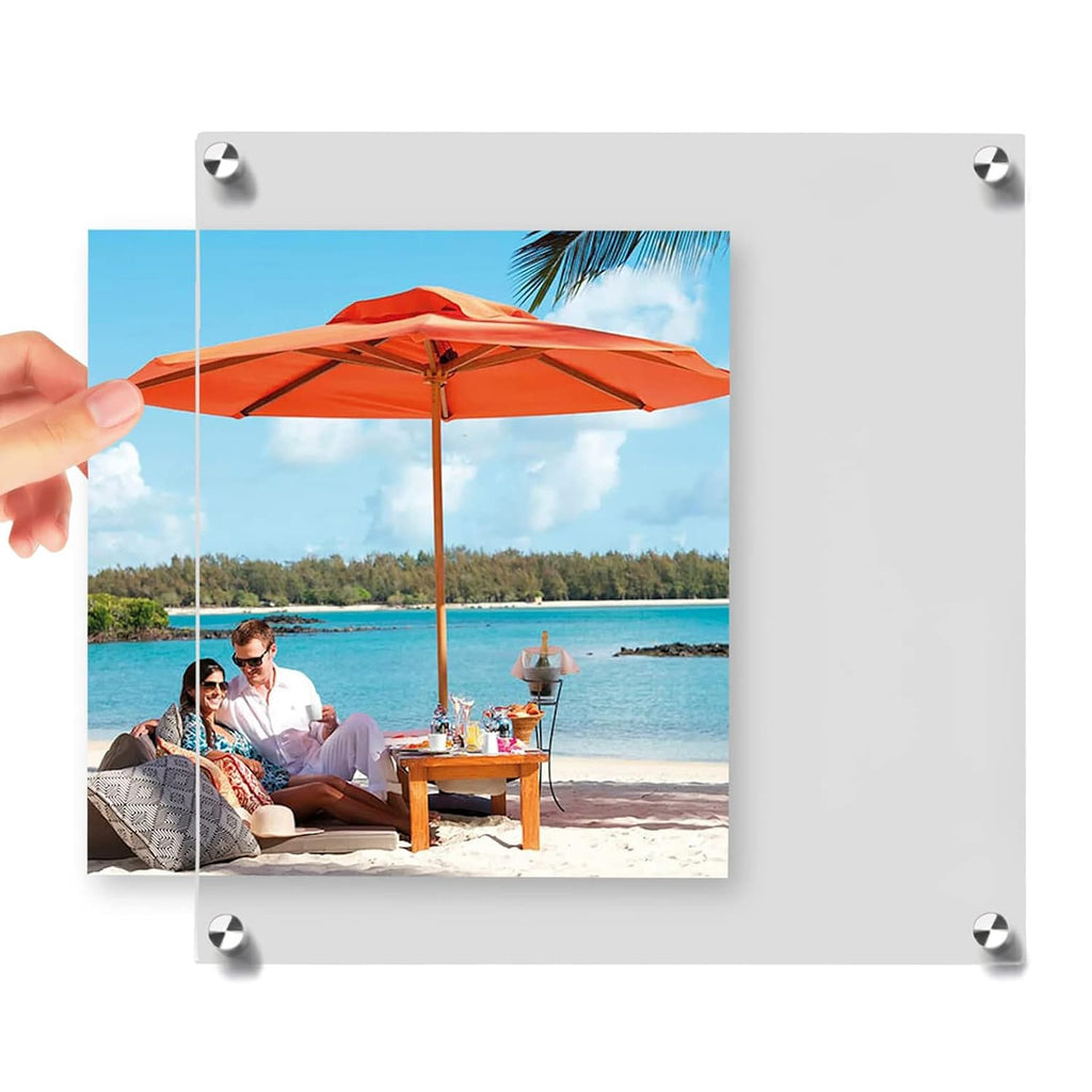 Hands inserting a beach scene photo into a clear acrylic frame: showcases easy photo replacement, with sturdy metal corner fasteners for secure closure
