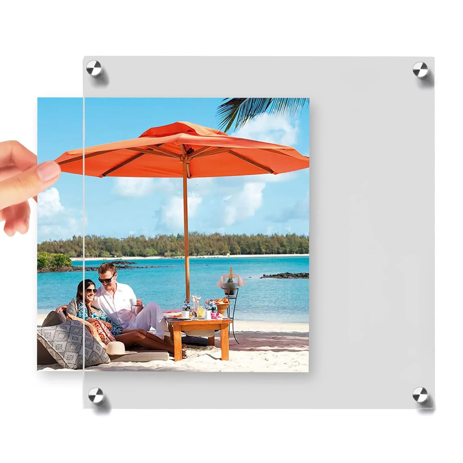 Hands inserting a beach scene photo into a clear acrylic frame: showcases easy photo replacement, with sturdy metal corner fasteners for secure closure