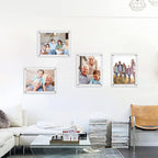 Set of acrylic photo frames arranged as a wall gallery in a living room, displaying family photos. Features high-transparency acrylic material and sleek metal fasteners, suitable for home decor