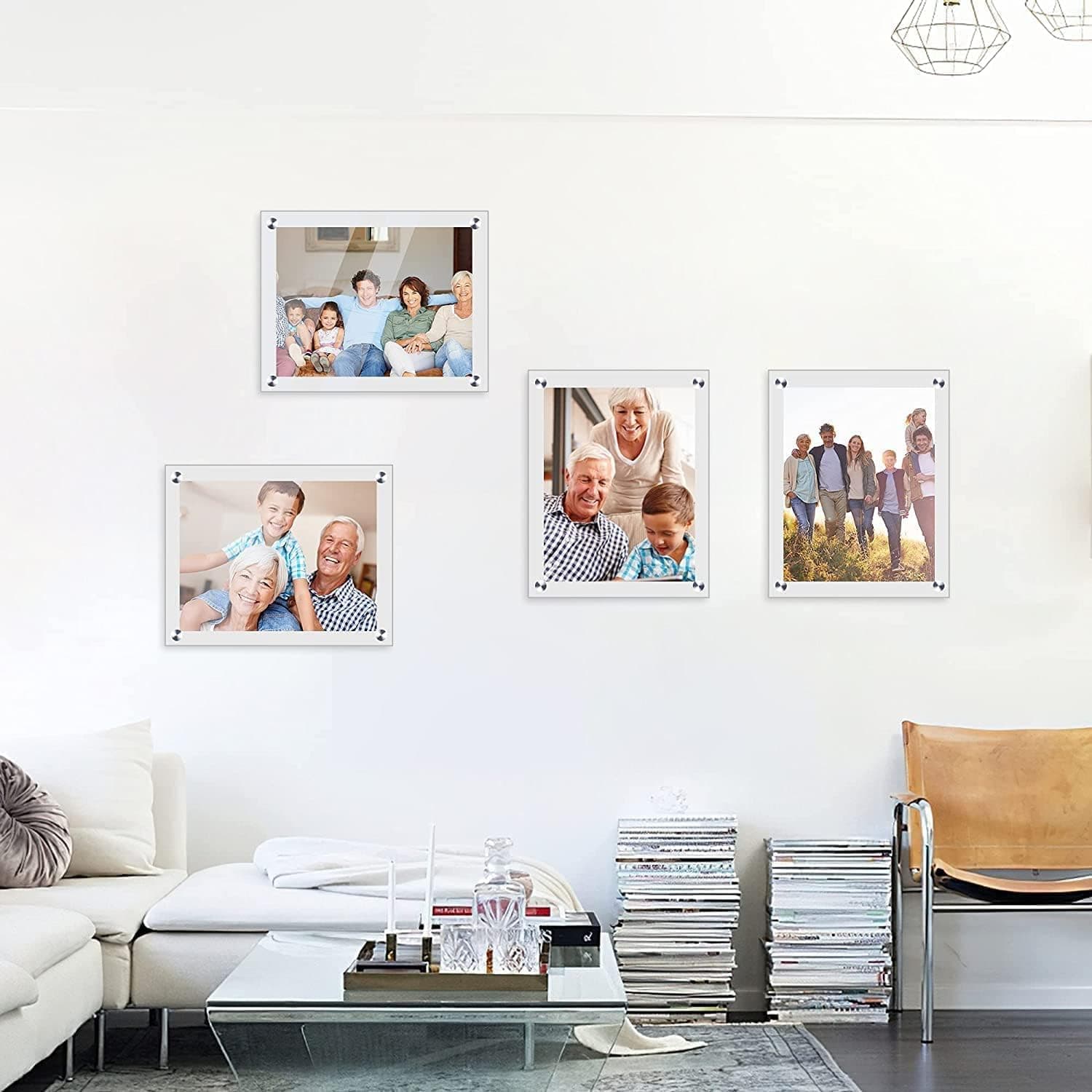 Set of acrylic photo frames arranged as a wall gallery in a living room, displaying family photos. Features high-transparency acrylic material and sleek metal fasteners, suitable for home decor