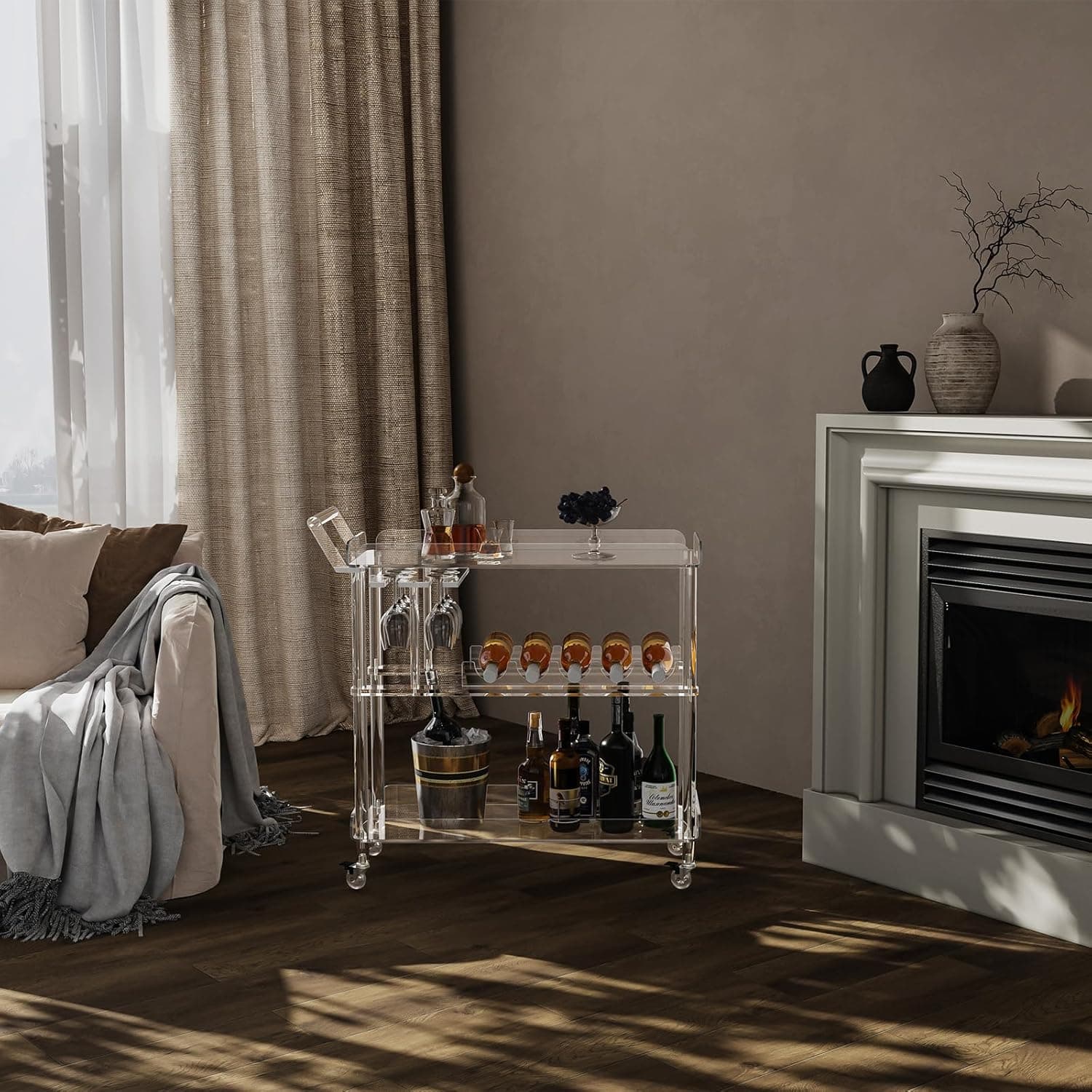 Acrylic bar cart styled in a cozy living room by a fireplace, decorated with wine and fruit for hosting