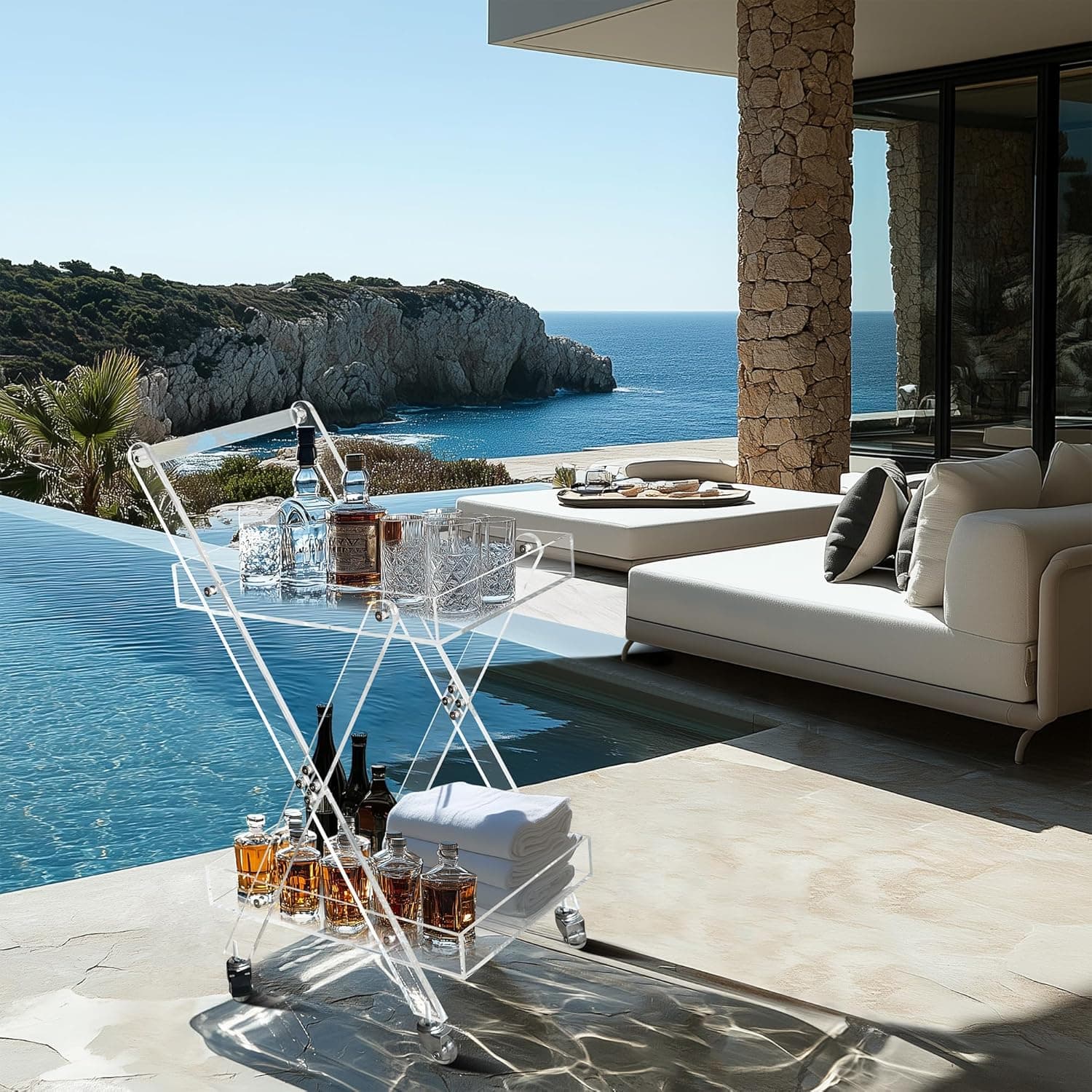 Acrylic rolling bar cart on a luxury outdoor patio overlooking the ocean