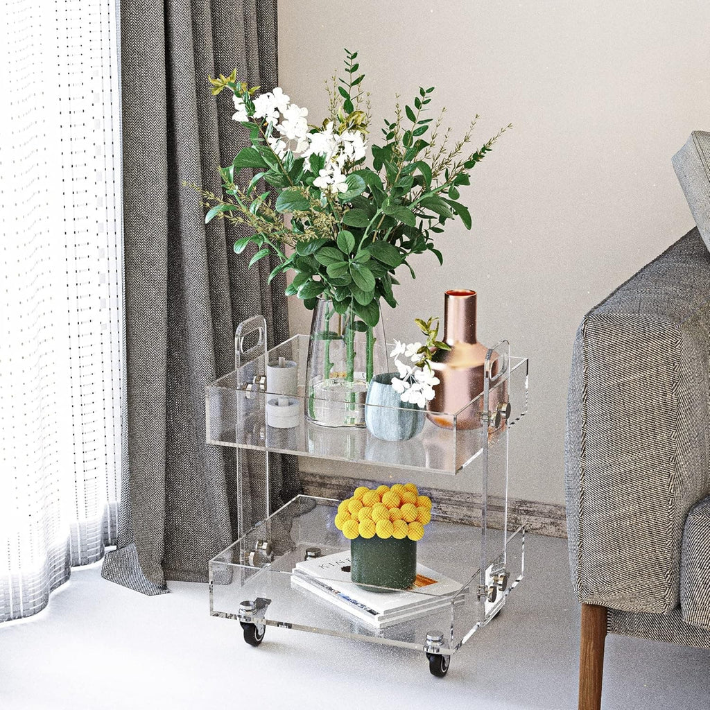 Clear acrylic bar cart styled with flowers and copper barware in a modern living space