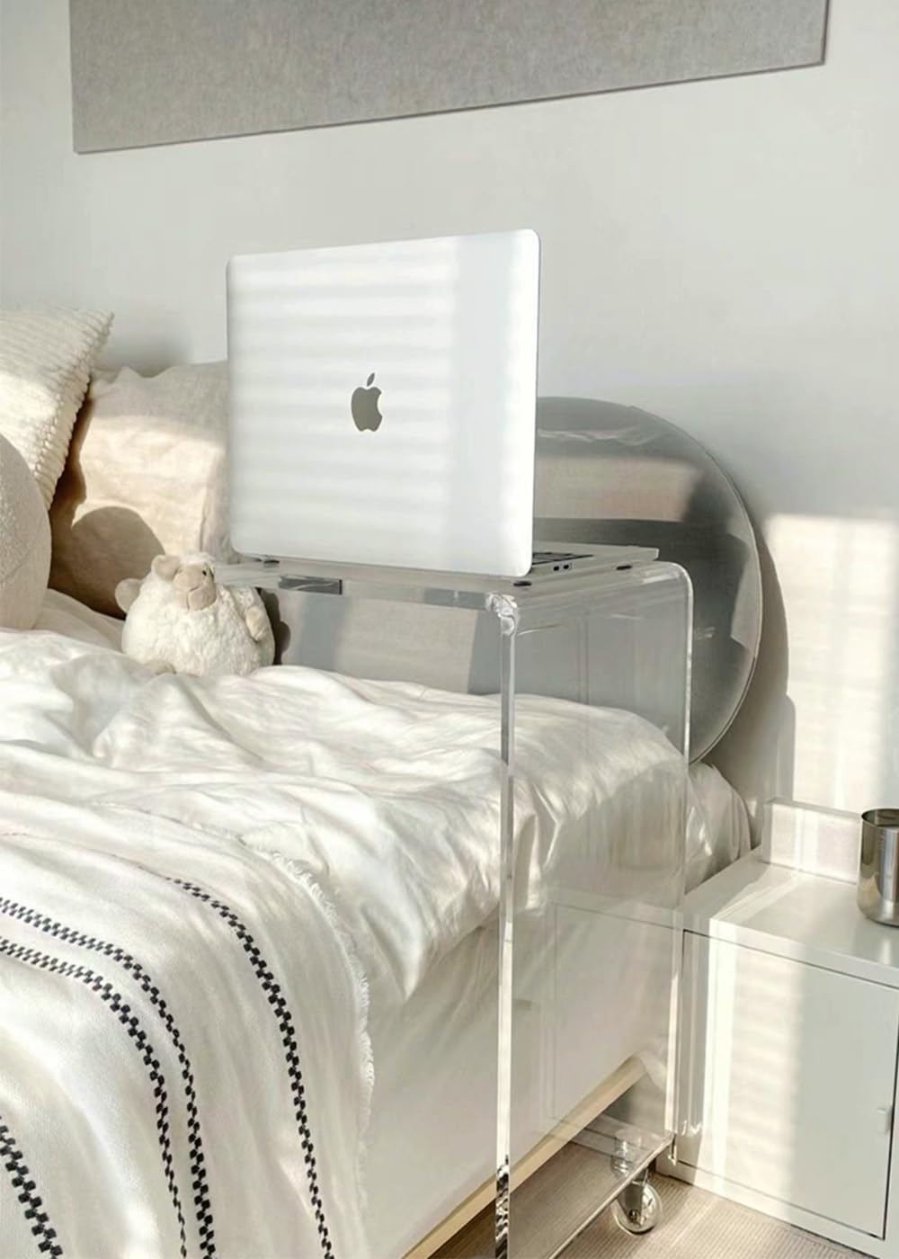 Acrylic C-table used as a laptop stand over a bed, demonstrating its multi-functional design.