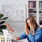 User interacting with a clear acrylic wall planner in a home office setting, with gold and silver hardware options