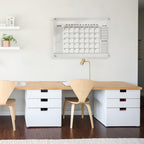 Acrylic wall calendar mounted in a Scandinavian-style home office, blending function and decor