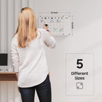 24×16 inch acrylic wall calendar size reference with user demonstrating writing