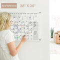 28×20 inch acrylic wall calendar size reference with a user demonstrating writing