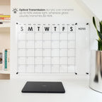 Ultra-clear acrylic wall calendar with 92% light transmission, displayed in a bright workspace