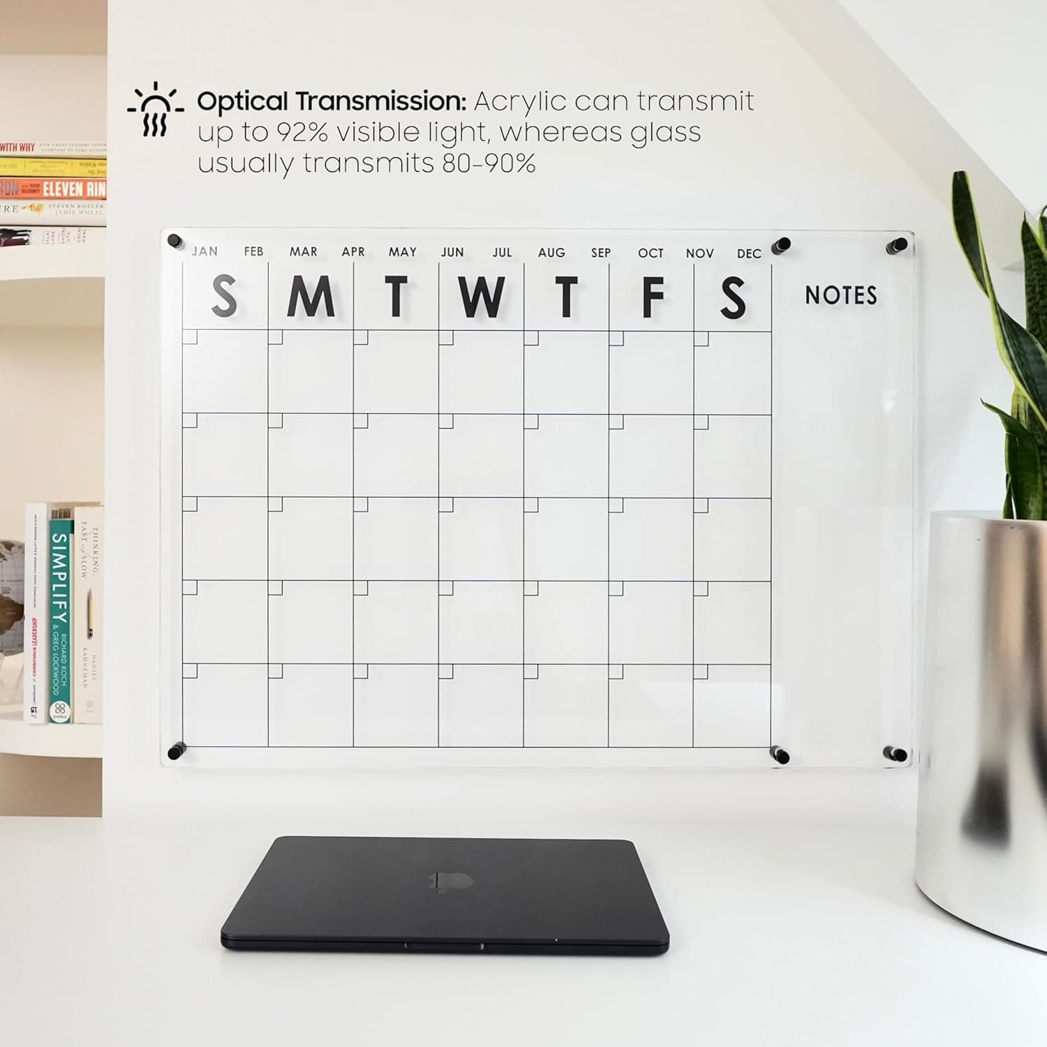 Ultra-clear acrylic wall calendar with 92% light transmission, displayed in a bright workspace