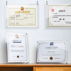 Acrylic frames displaying business licenses and certificates, mounted on wall and placed on desk