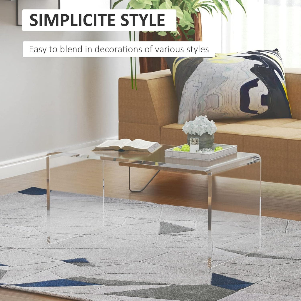 Clear acrylic coffee table in a minimalist living room, styled with a book and decorative tray, emphasizing its versatile design