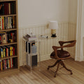 Modern clear acrylic desk with storage shelves in a light home office setting