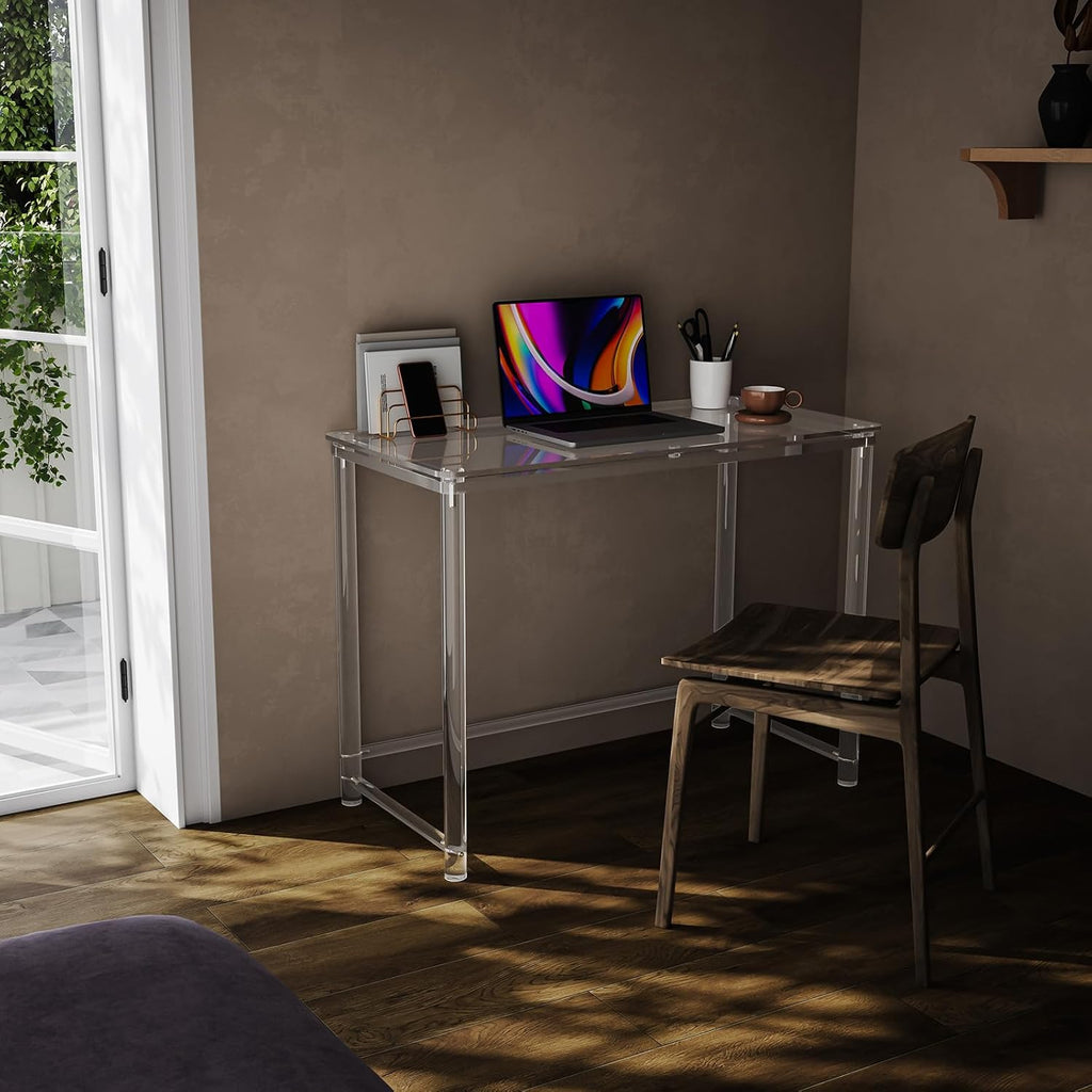 Transparent acrylic desk used as a workspace in a small room with a window
