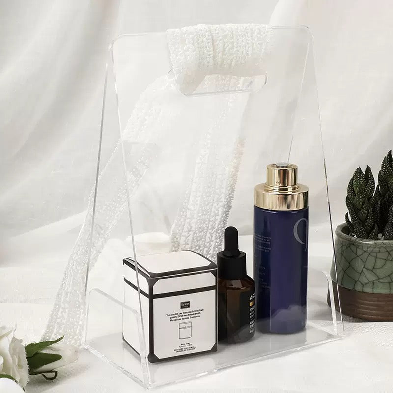 Clear acrylic handheld box used for storing skincare and cosmetic products