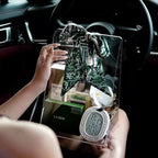 Clear acrylic handheld box used as a luxury gift bag, filled with premium skincare products