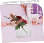 Clear acrylic flower box with a bouquet, displayed in a party setting with floral decor