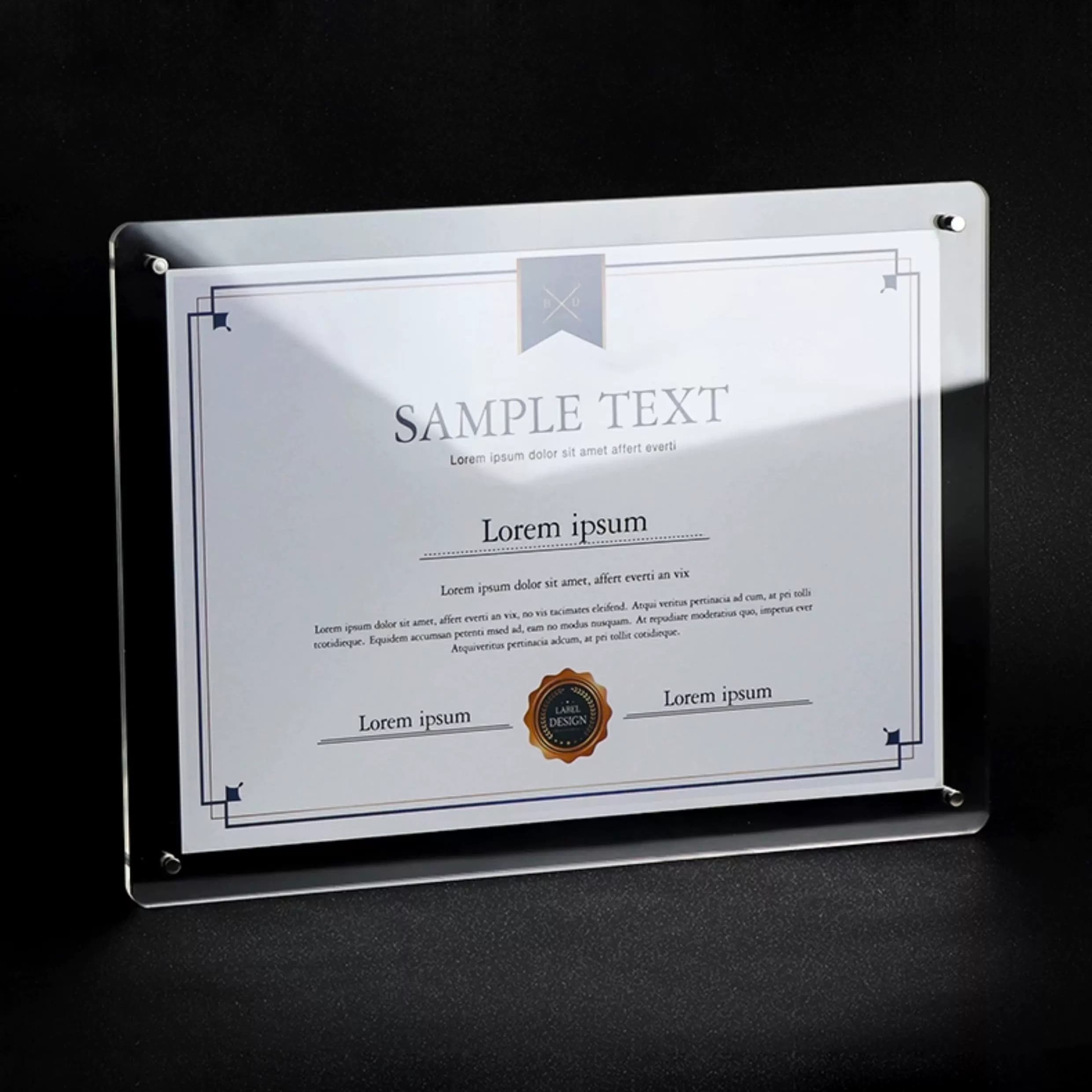 Close-up of clear acrylic document holder with sample certificate inside, placed on dark surface