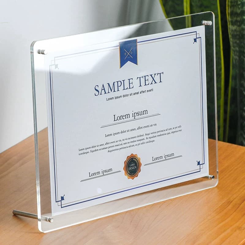 Clear acrylic frame with sample certificate, displayed on tabletop using metal stand