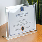 Clear acrylic frame with sample certificate, displayed on tabletop using metal stand