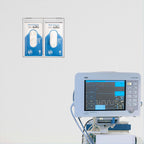 Wall-mounted 2-compartment acrylic dispenser next to a medical monitor in a hospital room