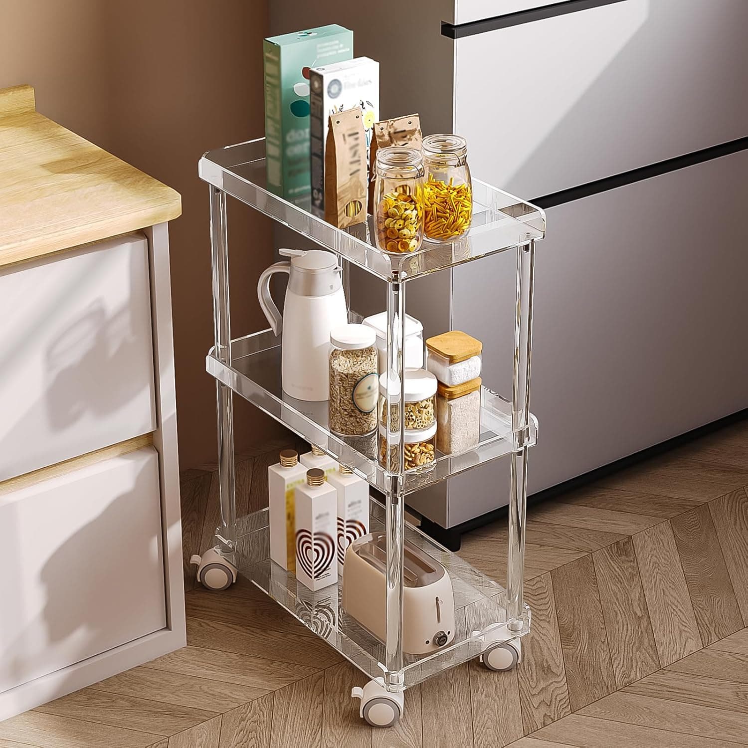 3-tier acrylic storage cart in a kitchen, holding pantry items and a kettle for easy access