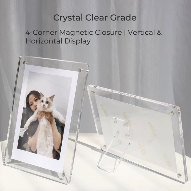 Clear acrylic magnetic photo frame standing vertically with a photo of a person and a cat