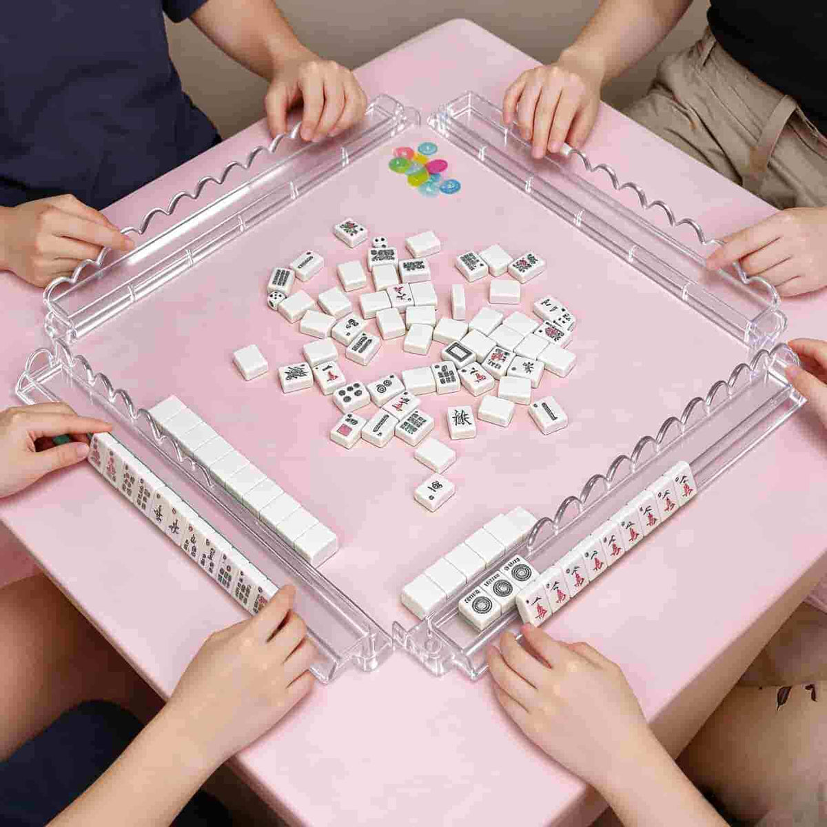 4 clear acrylic mahjong racks with magnetic pushers on pink table, playing American mahjong game scene, tiles for demo only