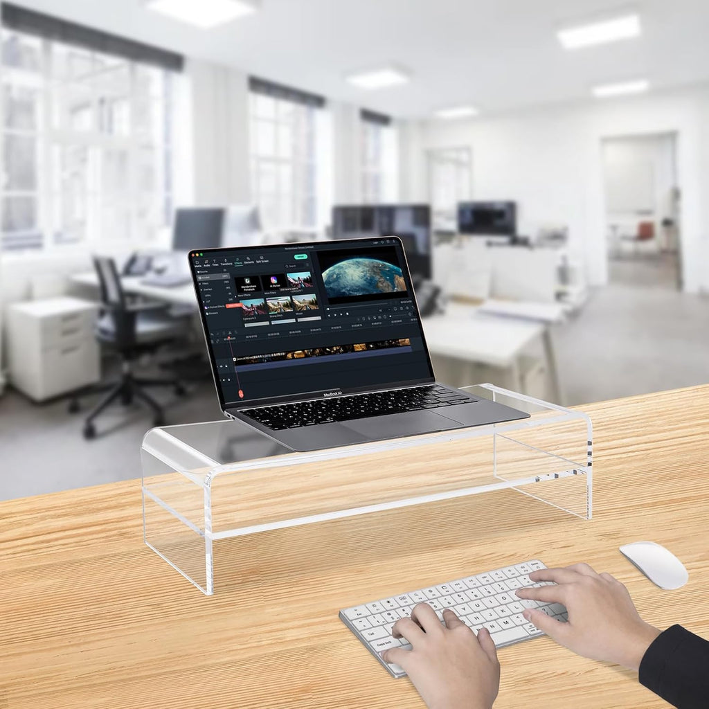 Acrylic monitor stand with a laptop in a modern office setting, enhancing productivity