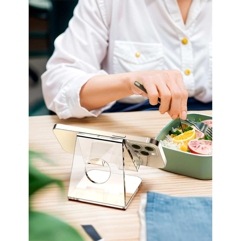 Clear acrylic phone stand used for hands-free video viewing during a meal