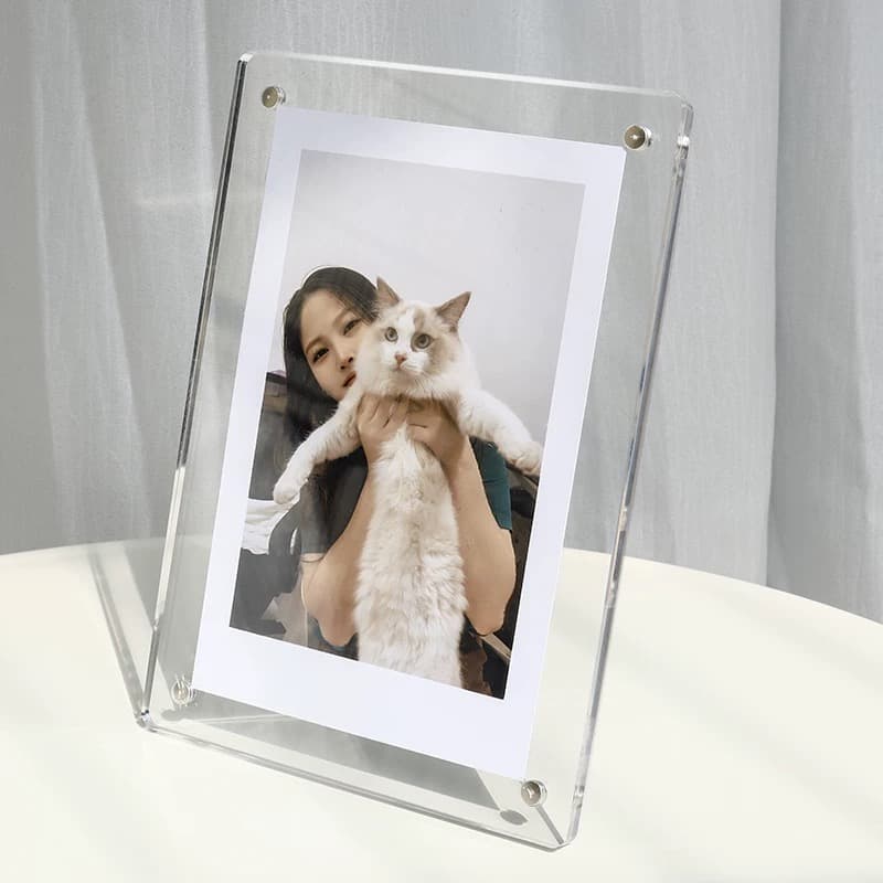 Clear acrylic magnetic photo frame (tabletop) holding a photo of a person with a fluffy white cat