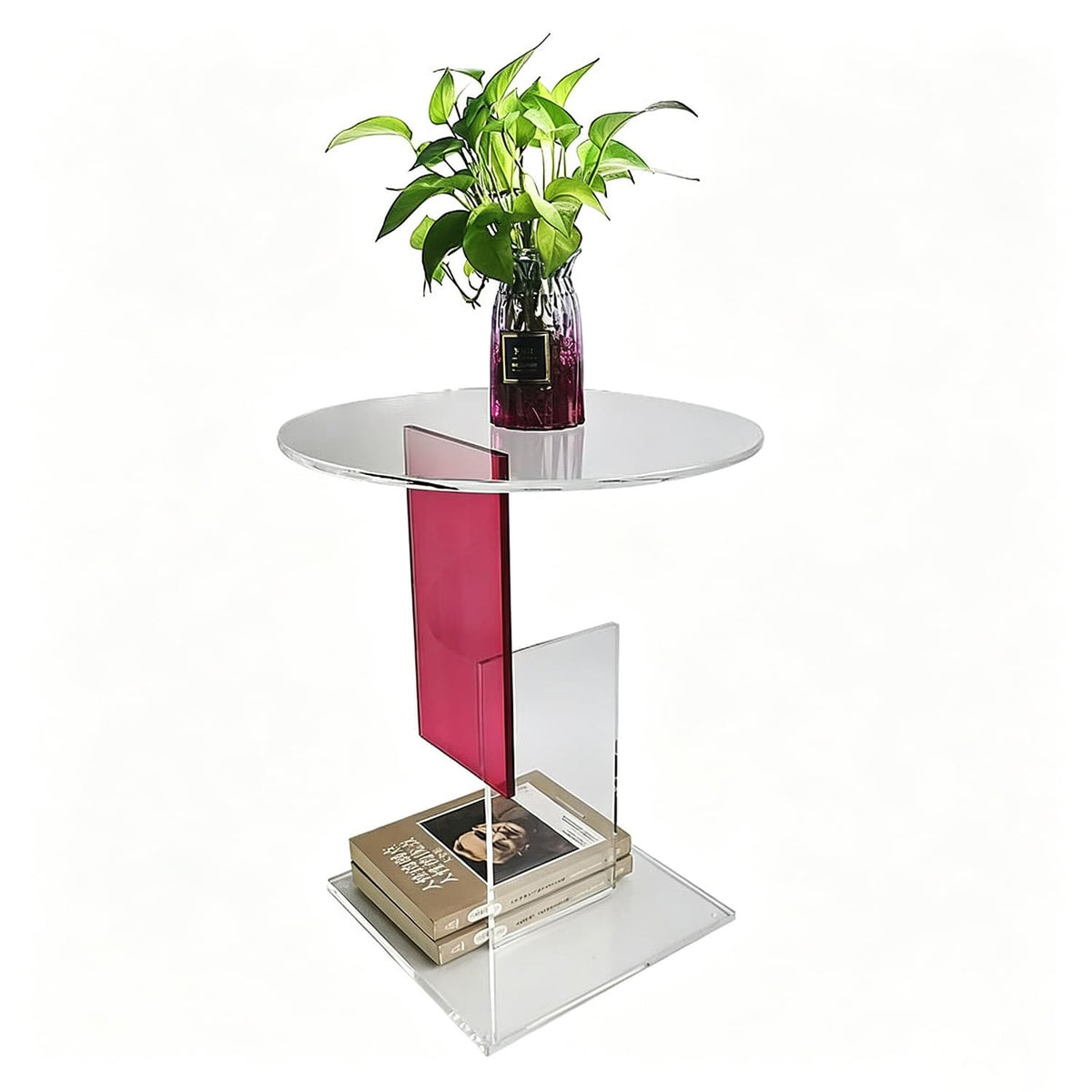 Modern clear acrylic round side table with pink accent, styled with potted plant and stacked books, product shot