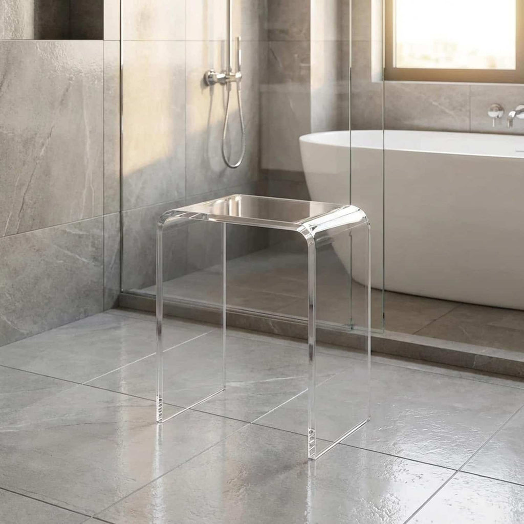 Clear acrylic shower stool in a modern luxury bathroom with a freestanding tub