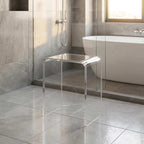 Clear acrylic shower stool in a modern luxury bathroom with a freestanding tub