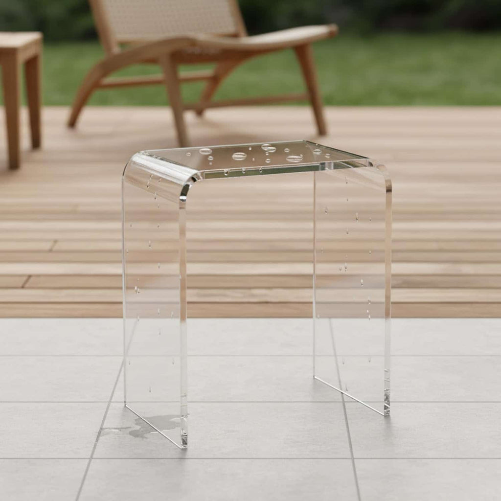 Water-resistant clear acrylic bench on a wet patio, suitable for both indoor and outdoor use
