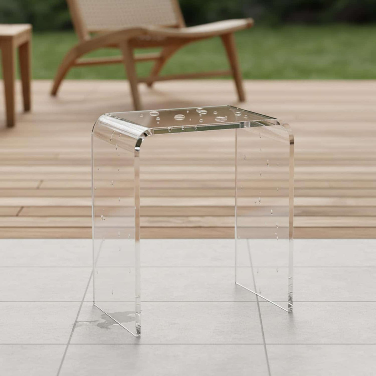 Water-resistant clear acrylic bench on a wet patio, suitable for both indoor and outdoor use