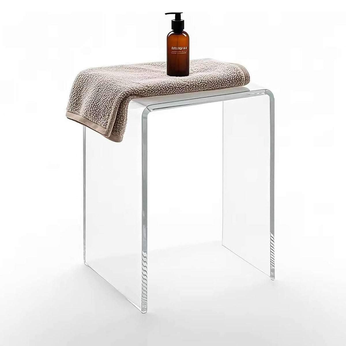 Clear acrylic shower bench with a towel and soap dispenser, modern transparent bathroom seat