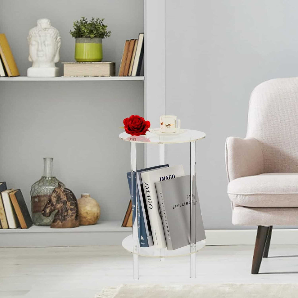 2-tier acrylic round side table next to a beige lounge chair, holding a coffee cup, red rose, and books