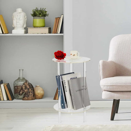 2-tier acrylic round side table next to a beige lounge chair, holding a coffee cup, red rose, and books