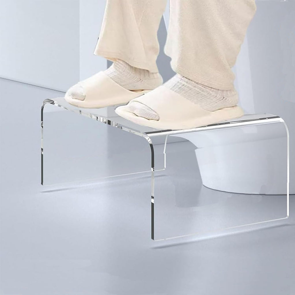 Transparent acrylic bench with towels and soap dispenser placed by a modern freestanding tub