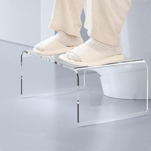 Transparent acrylic bench with towels and soap dispenser placed by a modern freestanding tub